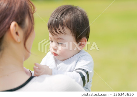 Baby carried by mother 126343630
