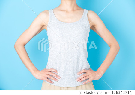 Middle-aged woman in a tank top with hands on hips Middle-aged woman in a tank top with hands on hips 126343714