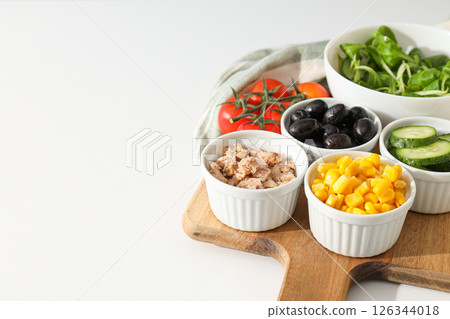 Cooking salad with tuna on a light background. Cooking salad with tuna on a light background. 126344018