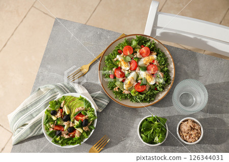 Salad with tuna on a gray table. Salad with tuna on a gray table. 126344031