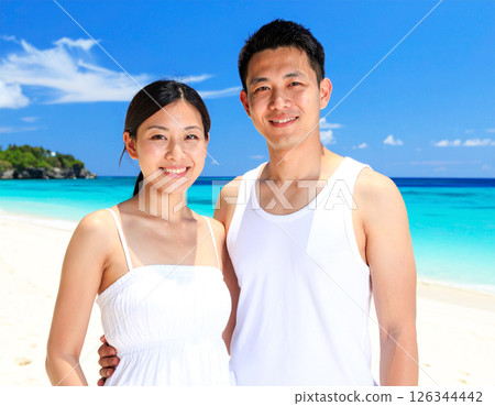 Beautiful tropical beach and smiling young couple Beautiful tropical beach and smiling young couple 126344442