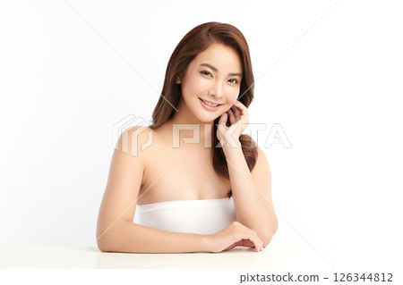 A beautiful young Asian woman with clean, fresh skin against a white background. Skincare, facial treatment, cosmetology, beauty, and spa. An elegant portrait of an Asian woman. 126344812