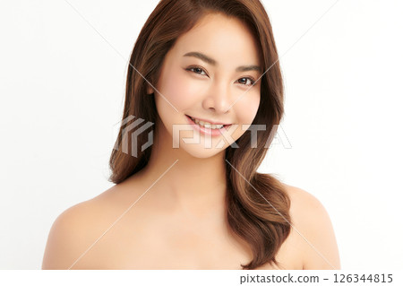 A beautiful young Asian woman with clean, fresh skin against a white background. Skincare, facial treatment, cosmetology, beauty, and spa. An elegant portrait of an Asian woman. 126344815