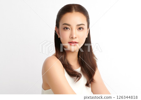 A beautiful young Asian woman with clean, fresh skin against a white background. Skincare, facial treatment, cosmetology, beauty, and spa. An elegant portrait of an Asian woman. 126344818
