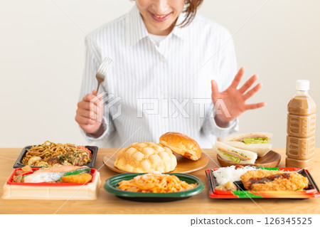 Middle-aged woman eating a lot 126345525