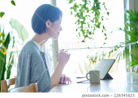 Woman working in the living room 126345825