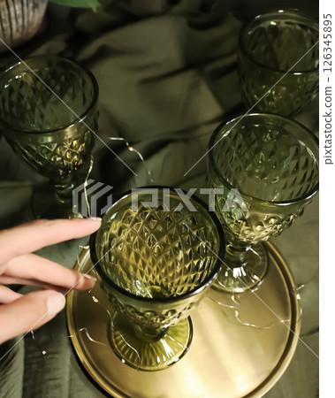 elegant green drinking set of glasses on a golden tray 126345895