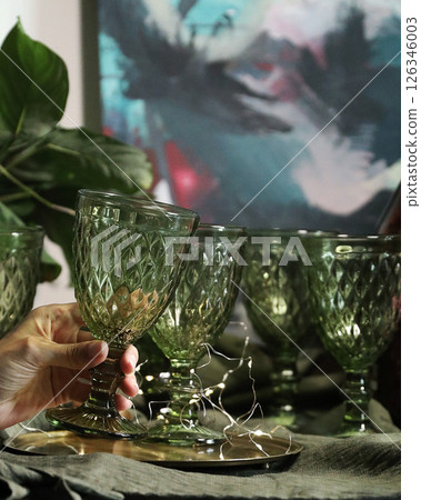 Set of elegant green drinking glasses on a golden tray 126346003
