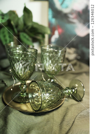 Set of elegant green drinking glasses on a golden tray Set of elegant green drinking glasses on a golden tray 126346012