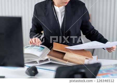 A female employee checking construction documents 126346512
