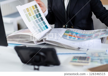 A female employee checking construction documents 126346515