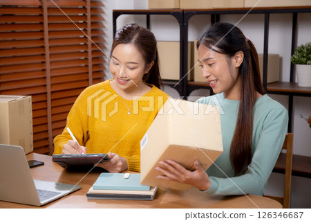 Two young asian woman working while planning online business and checking order. 126346687