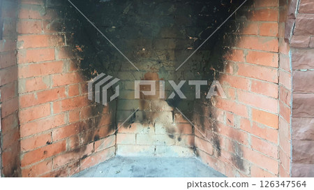 Dirty brick fireplace needing cleaning after intense usage Dirty brick fireplace needing cleaning after intense usage 126347564