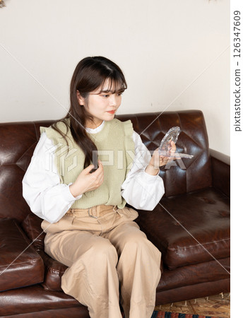 A woman touching up her makeup 126347609