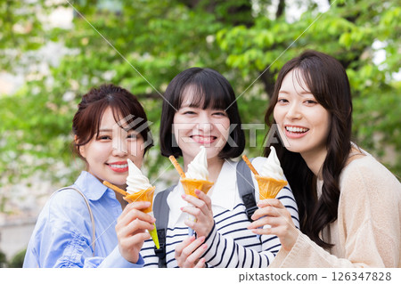 A woman eating a soft cream 126347828
