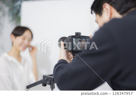 Male cameraman taking a video Male cameraman taking a video 126347957