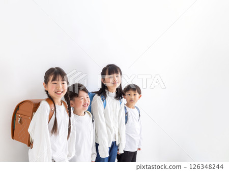 Smiling elementary school student carrying a backpack 126348244