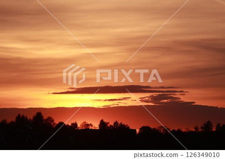 The sky is orange and the sun is setting 126349010