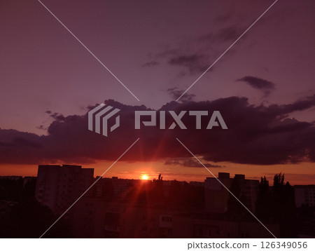 Pink order over the city with dark lilac clouds 126349056