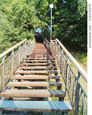 Metal staircase up between trees in park 126349076