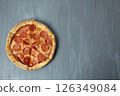Round pepperoni on pizza on a gray background, upper angle. Pepperoni Pizza Day 126349084