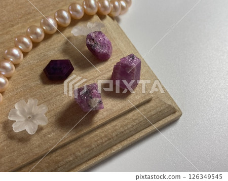 Pearl and ruby rough on wood 126349545