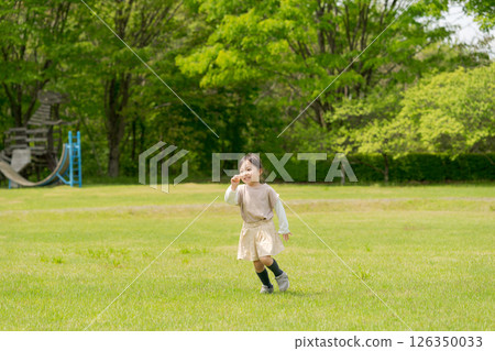 Girls playing in the park Girls playing in the park 126350033