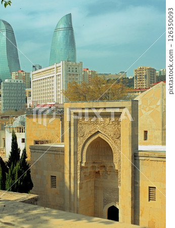 Baku city, Azerbaijan, view of historic mosques and walls of the Shirvanshahs Palace in the Old City and modern glass Flame Towers Baku city, Azerbaijan, view of historic mosques and walls of the Shirvanshahs Palace in the Old City and modern glass Flame Towers 126350093