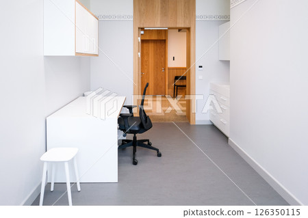 A doctor's office with a couch and a chair to examine a patient's health. Clean, bright hospital interior 126350115