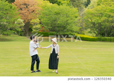 Family walking in a large park 126350340