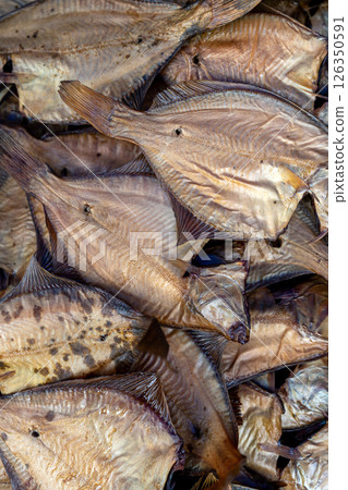 Dried fish on display at a lively market, highlighting local seafood preservation for sale. Dried fish on display at a lively market, highlighting local seafood preservation for sale. 126350591