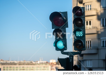 Green traffic light showing bus signal in an urban area during a clear day Green traffic light showing bus signal in an urban area during a clear day 126351513