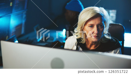Woman, hacker or reading on computer at night for programming, cyber attack or online information. Mature person, pc or late research for website phishing, data protection or criminal with fraud risk Woman, hacker or reading on computer at night for programming, cyber attack or online information. Mature person, pc or late research for website phishing, data protection or criminal with fraud risk 126351722