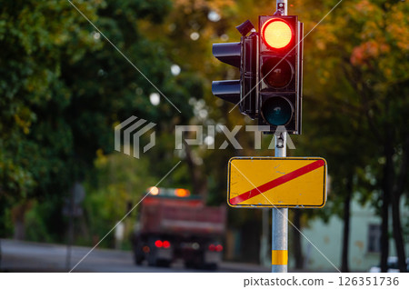 traffic semaphore with red light on defocused background of autumn city, closeup 126351736
