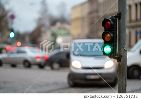 traffic light on the street junction with beautiful bokeh, city with cars in the background 126351738