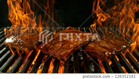 Different types of grilled meat on charcoal grill with Flames. Isolated on Black Background. Different types of grilled meat on charcoal grill with Flames. Isolated on Black Background. 126352181