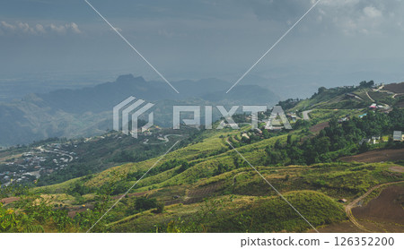 Scenic mountain village landscape under cloudy sky Scenic mountain village landscape under cloudy sky 126352200