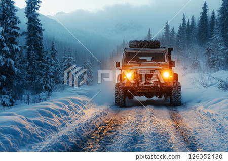 Rugged 4x4 off-road truck covered in snow cuts through icy mist on a remote forest trail, headlights piercing fog in a bold winter overlanding challenge 126352480