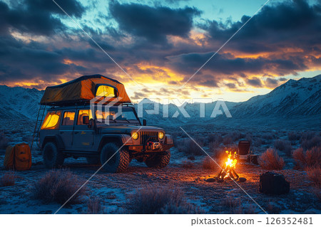 A lone traveler sets up camp near 4x4 with rooftop tent and glowing campfire, embracing the quiet, nomadic life under a vast desert sky at dusk 126352481