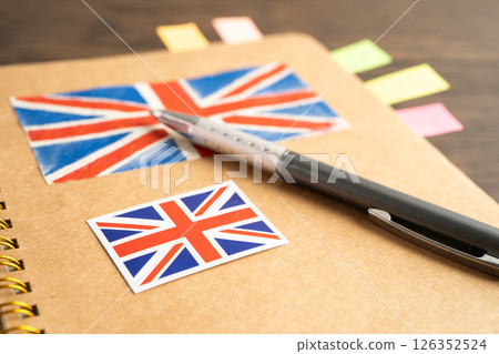 UK flag with pen on english language book. UK flag with pen on english language book. 126352524