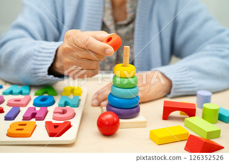 Alzheimer disease AD, Asian elderly woman patient suffering from dementia learn practical motor skills rehabilitation. 126352526