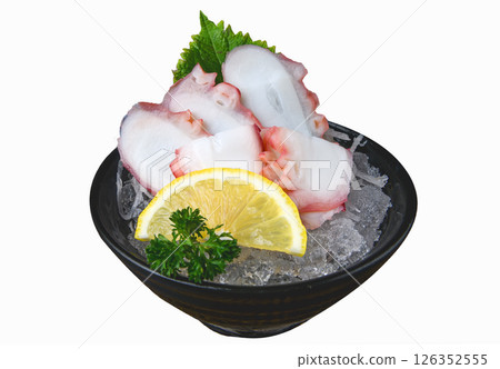 Octopus sashimi slices with lemon and shiso leaf on crushed ice 126352555