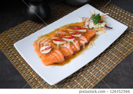 Salmon sashimi with ponzu sauce and grated daikon on white plate Salmon sashimi with ponzu sauce and grated daikon on white plate 126352566