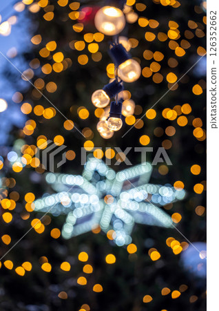 Christmas tree with yellow garlands lights and bokeh copy space 126352662