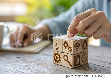 concept of digital transformation strategy, person building technology solution cube with innovation and connectivity icons on rustic wooden desk concept of digital transformation strategy, person building technology solution cube with innovation and connectivity icons on rustic wooden desk 126352695