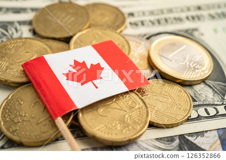 Stack of coins with Canada flag and US dollar banknotes. 126352866