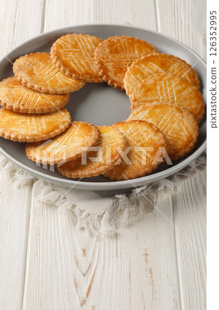 Sable Breton is a classic, very buttery cookie coming from the Bretagne region closeup on the plate. Vertical 126352995