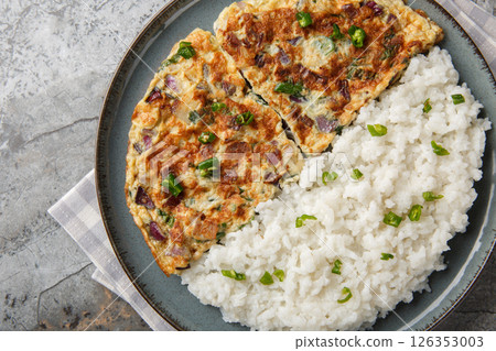 Motta Porichathu or Spicy Coconut Ginger Omelette, is a flavorful dish from Kerala, India closeup on the plate. Horizontal top view 126353003