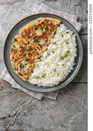 Spicy Kerala coconut ginger omelette Motta Porrichu with rice closeup on the plate. Vertical top view 126353004