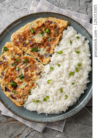 Motta Porrichu Spicy Coconut Ginger Omelette with rice closeup on the plate. Vertical top view 126353005